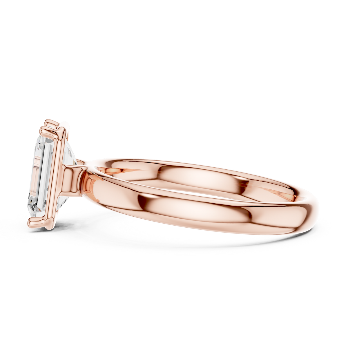 Rose gold emerald-cut solitaire diamond ring, profile view with four-prong head