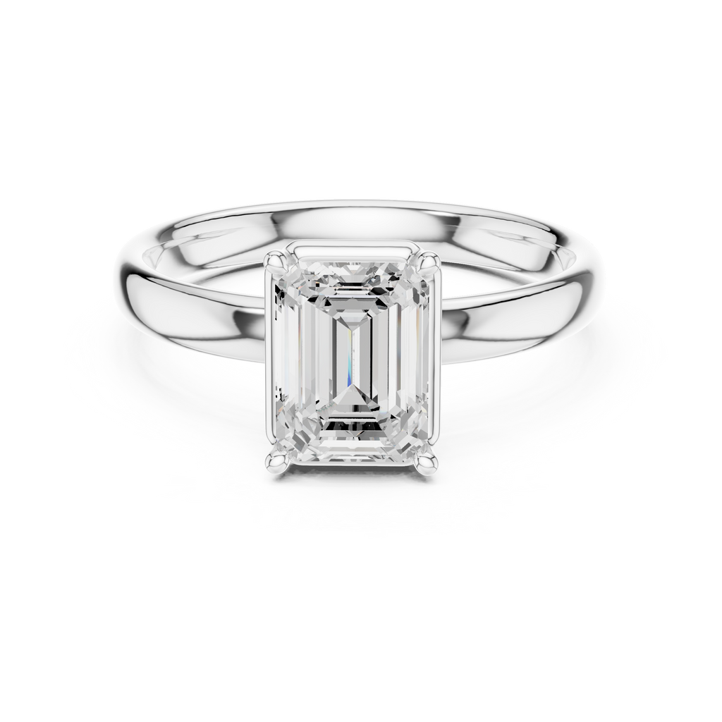 Emerald-cut diamond solitaire ring with polished silver-toned band and prong-set stone.