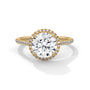 Round halo engagement ring with prong-set center stone, yellow gold tone and pavé diamonds