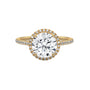 Round halo engagement ring with prong-set center stone, yellow gold tone and pavé diamonds