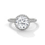 Round halo engagement ring with prong-set center stone, white metal and pavé diamond halo