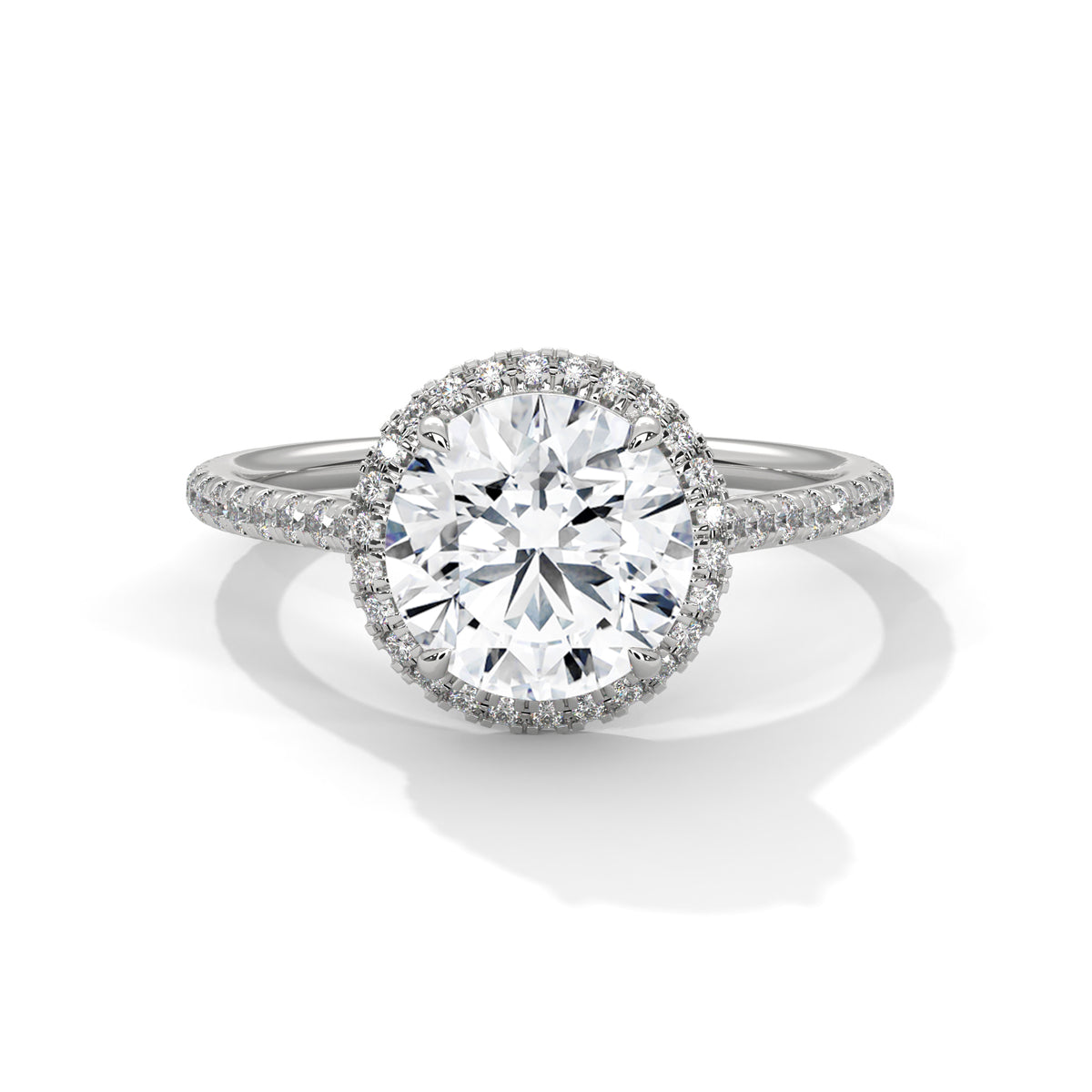 Round halo engagement ring with prong-set center stone, white metal and pavé diamond halo
