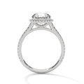 Round halo engagement ring with prong-set center stone, white metal and pavé details