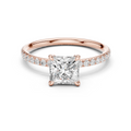 Rose gold solitaire engagement ring with princess center stone and diamond side band