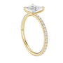 Yellow gold diamond ring with large faceted center stone and pavé halo, angled view