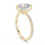Gold-tone engagement ring with pear-shaped center stone and pavé side band