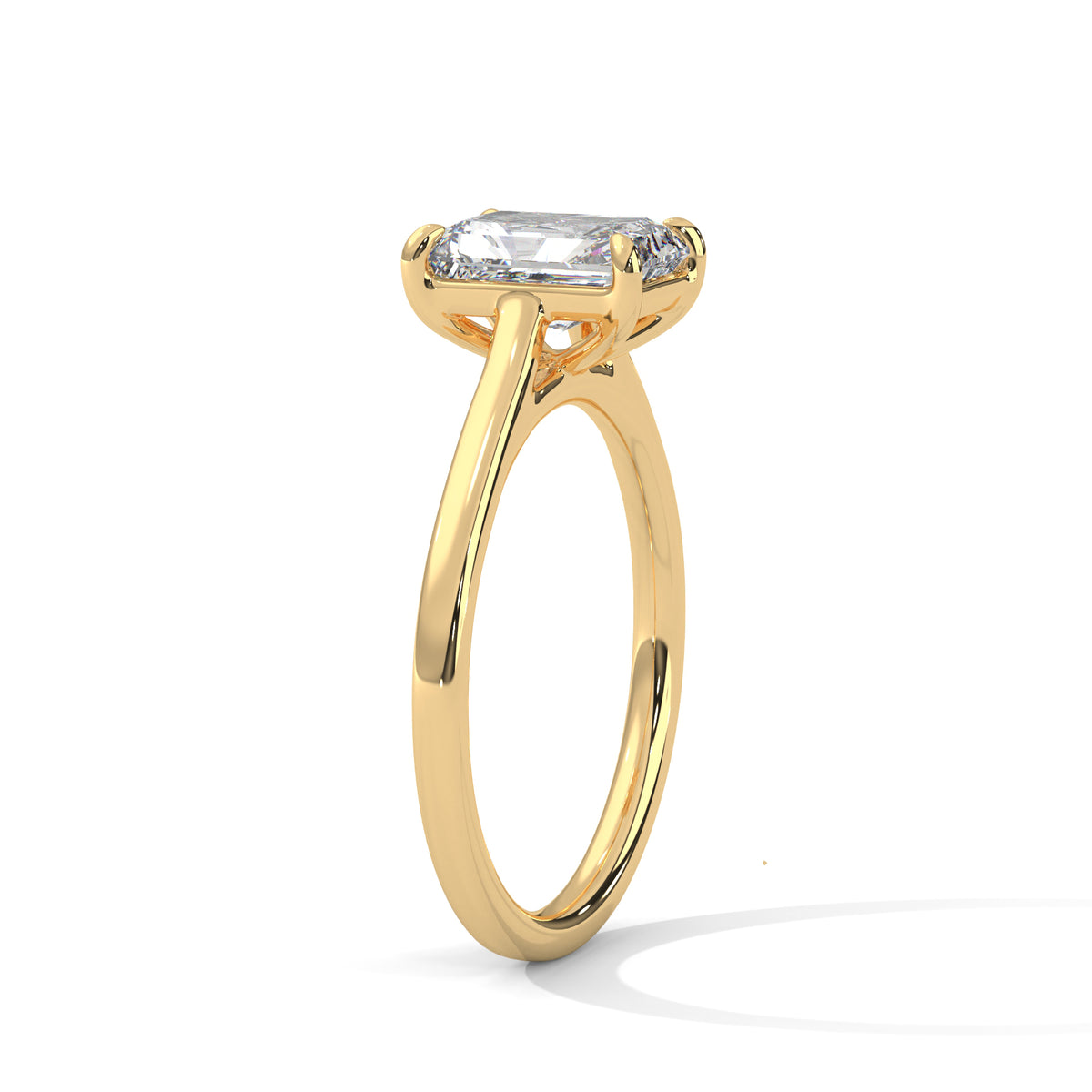 Yellow gold solitaire engagement ring, emerald-cut center stone in trellis prong setting