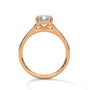 Rose gold solitaire engagement ring with emerald-cut center stone and trellis prongs
