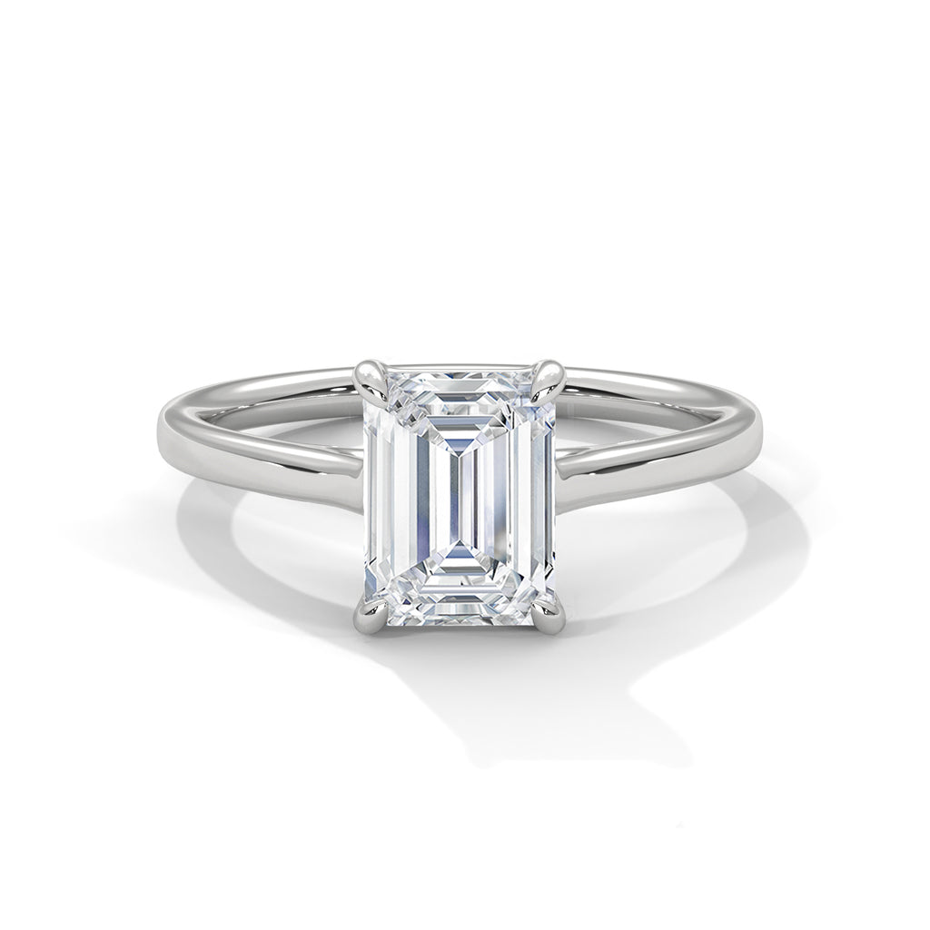 Platinum solitaire engagement ring with emerald-cut center stone in four-prong trellis setting