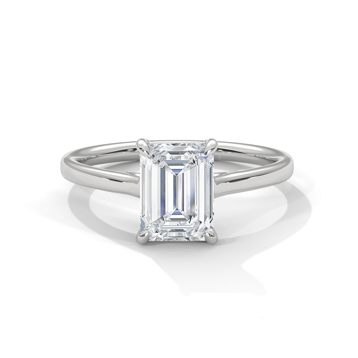 Platinum solitaire engagement ring with emerald-cut center stone in four-prong trellis setting
