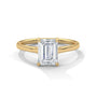 Yellow gold solitaire engagement ring with emerald-cut center stone in four-prong trellis setting