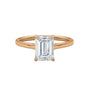 Rose gold solitaire engagement ring with emerald-cut center stone in four-prong trellis setting