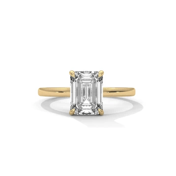 Diamond solitaire ring with emerald-cut center stone and four-prong setting, yellow gold