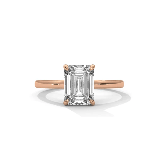 Diamond solitaire ring with emerald-cut center stone and four-prong setting, rose gold