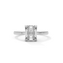 Diamond solitaire ring with emerald-cut center stone and four-prong setting, silver metal