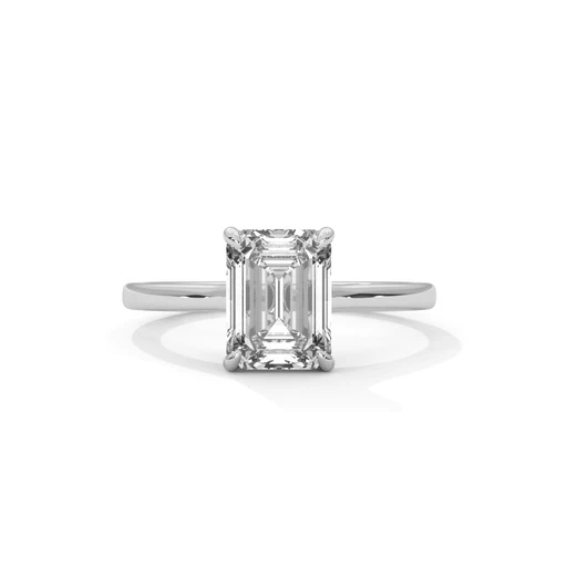 Diamond solitaire ring with emerald-cut center stone and four-prong setting, silver metal