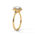 Yellow gold engagement ring with round center stone and floral halo, side view.