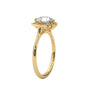 Yellow gold engagement ring with round center stone and floral halo, side view.