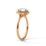 Rose gold engagement ring with round center stone and floral halo, side view.