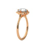 Rose gold engagement ring with round center stone and floral halo, side view.