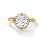 Yellow gold round halo engagement ring with prong-set center stone, 3/4 view.
