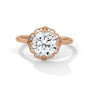 Rose gold round halo engagement ring with prong-set center stone, 3/4 view.