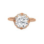 Rose gold round halo engagement ring with prong-set center stone, 3/4 view.