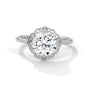 White gold round halo engagement ring with prong-set center stone, 3/4 view.