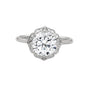 White gold round halo engagement ring with prong-set center stone, 3/4 view.