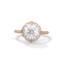 Round diamond halo ring with large center stone, rose gold band and side diamonds