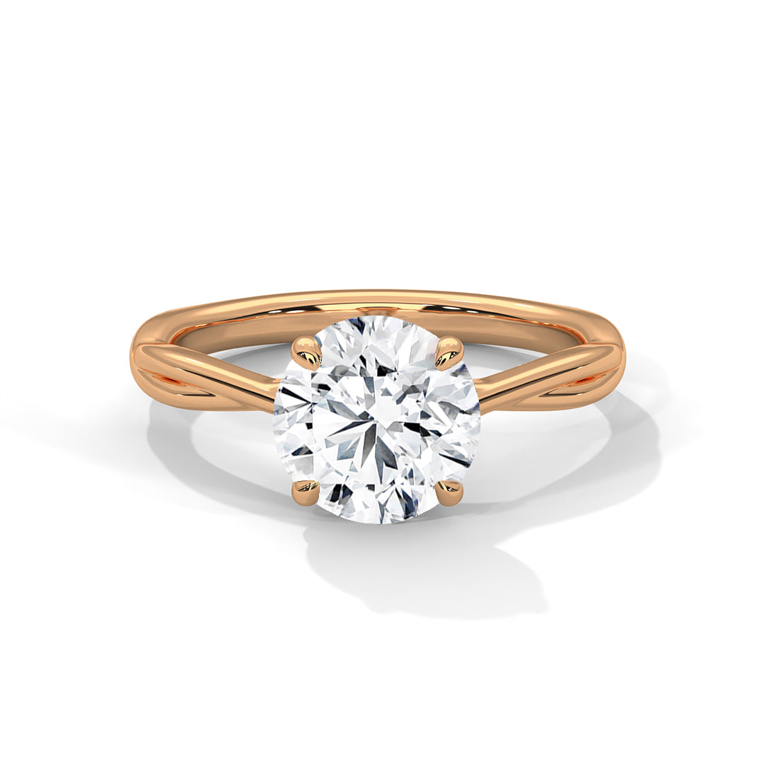 Twisted solitaire diamond ring in yellow gold with round prong-set diamond