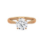 Twisted solitaire diamond ring in yellow gold with round prong-set diamond