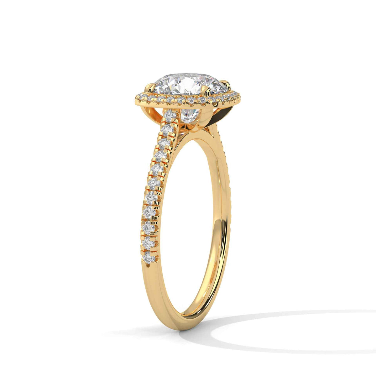 Cushion halo diamond ring side view with pavé stones and prong-set cushion center in gold